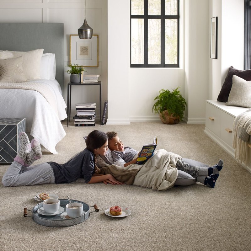 reading while sitting on soft carpet from Deloreto Flooring Inc in Winter Park