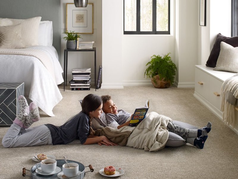 reading while sitting on soft carpet on Winter Park, FL area by Deloreto Flooring Inc